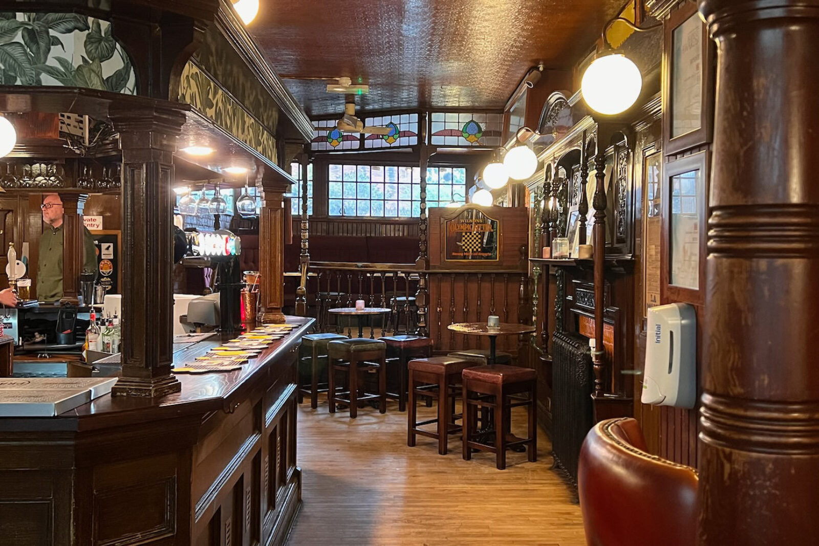 A traditional English pub, lots of dark wood, highly decorated